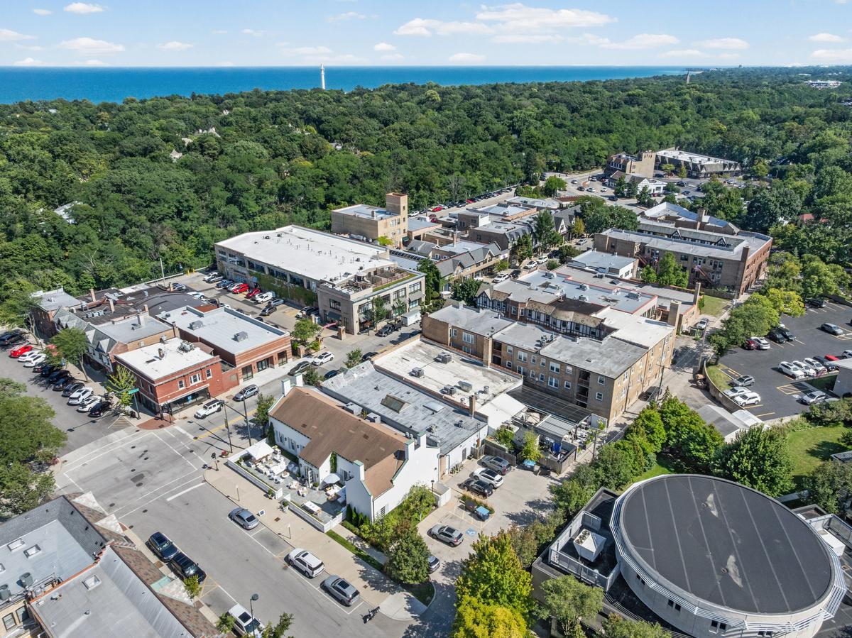 Aerial view of downtown Glencoe rooftops and the surrounding tree canopy