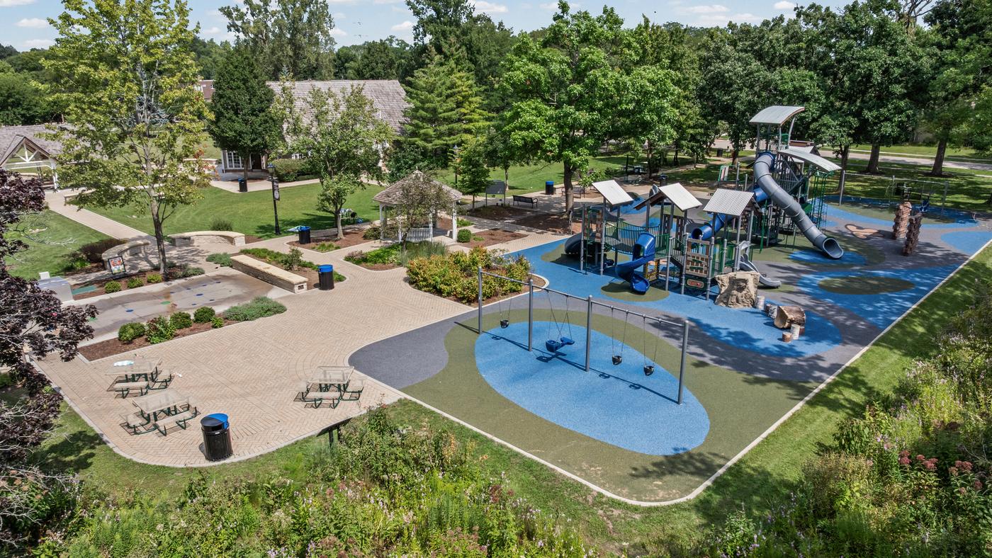 The playground at Clarkson Park, Northfield Park District, with swings, climbing structures and picnic tables